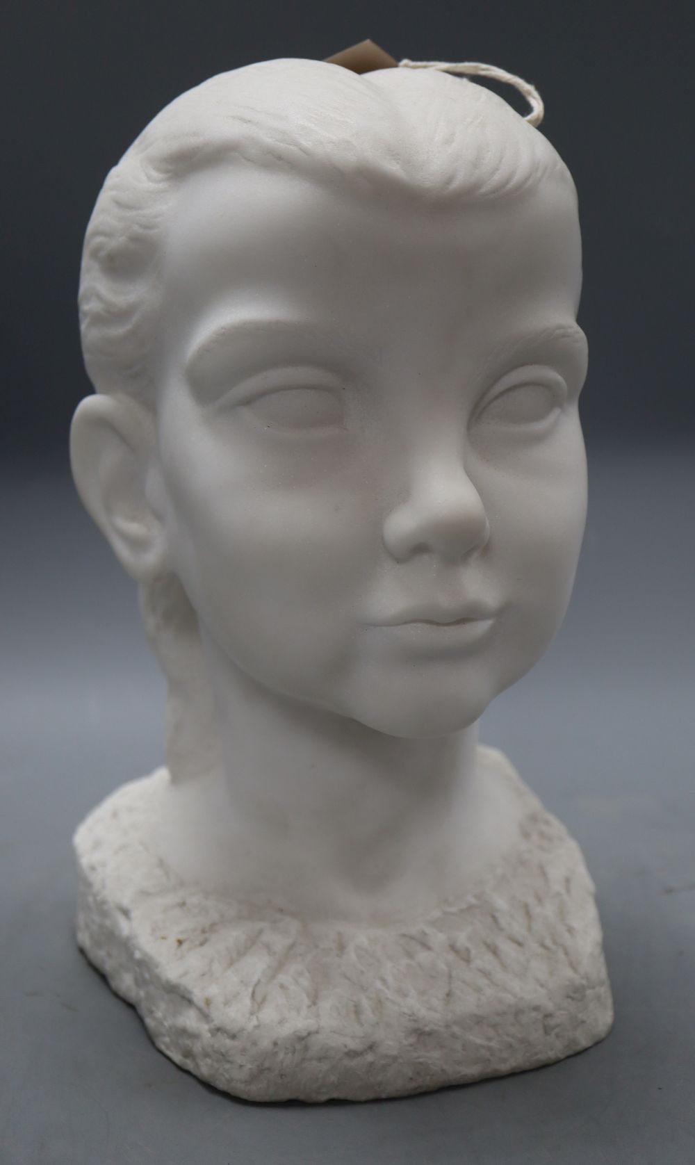 A carved marble head of a girl, signed Lankas 1947, height 29cm